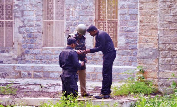 Police at Nimhans where an undertrial, Vishwanath, had snatched a rifle from a guard and fired 23 rounds, in Bengaluru on Sunday Police at Nimhans where an undertrial, Vishwanath, had snatched a rifle from a guard and fired 23 rounds, in Bengaluru on Sunday